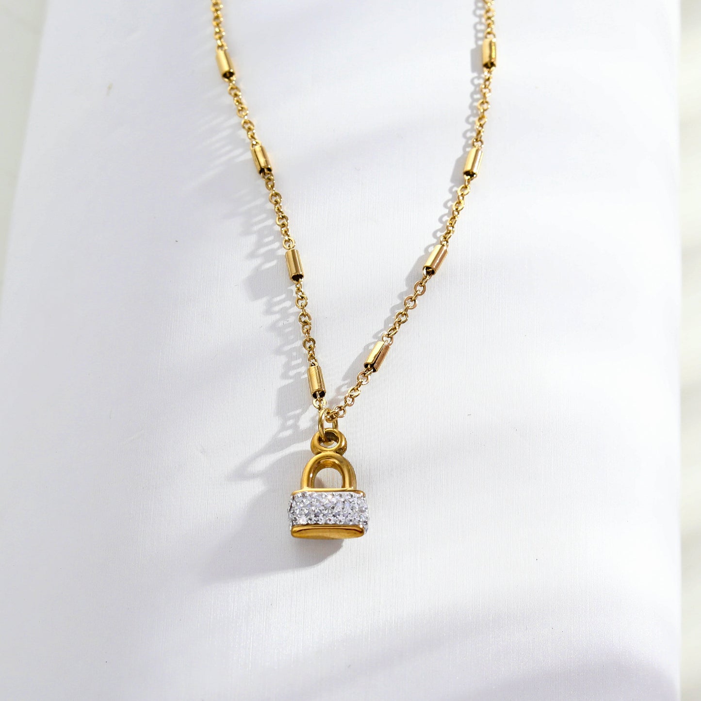 Style ABENI: Pavé Zirconia Pad Lock Pendant on a Tube Bead Chain Necklace in Gold