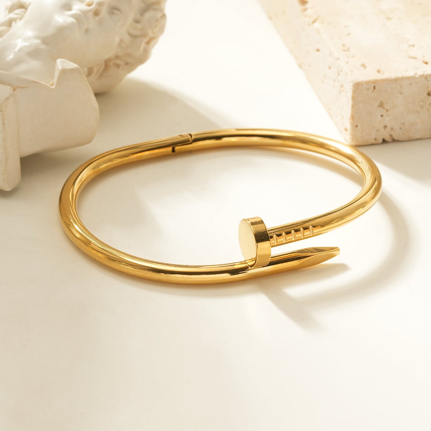 AGOTA Gold: Industrial-Chic Twisted Nail Bracelet