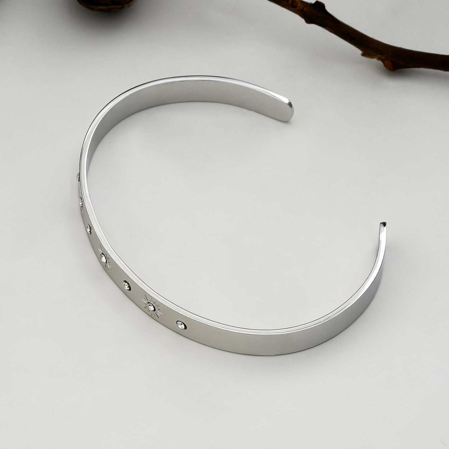 CHIMAKAK: Star-Engraved Zirconia Embedded Band Bracelet in Silver Toned White Gold