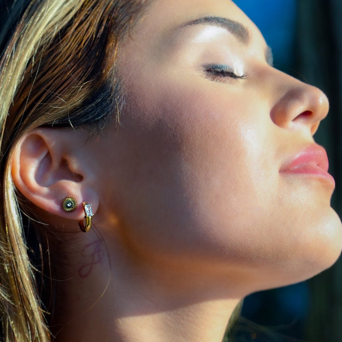 Style CONWYN: Retro Style Hoops with an Encased Clear Zirconia Charm in Gold.