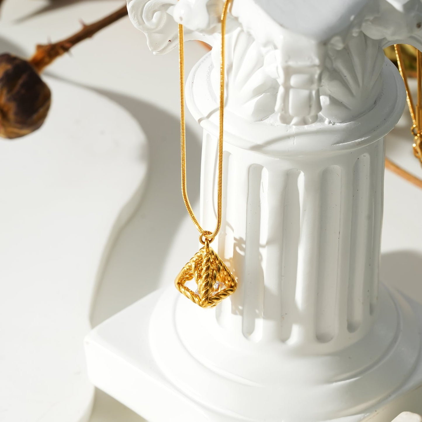 Style KARJAT: Gold Chain Necklace with Geometric Caged Zirconia Pendant