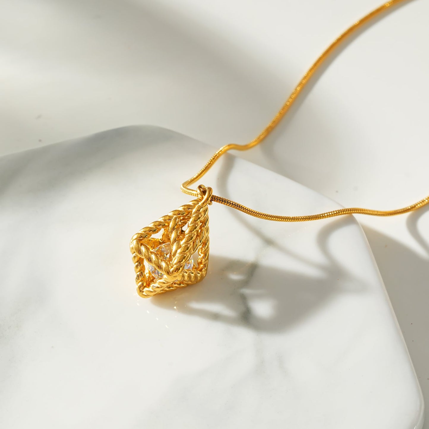 Style KARJAT: Gold Chain Necklace with Geometric Caged Zirconia Pendant