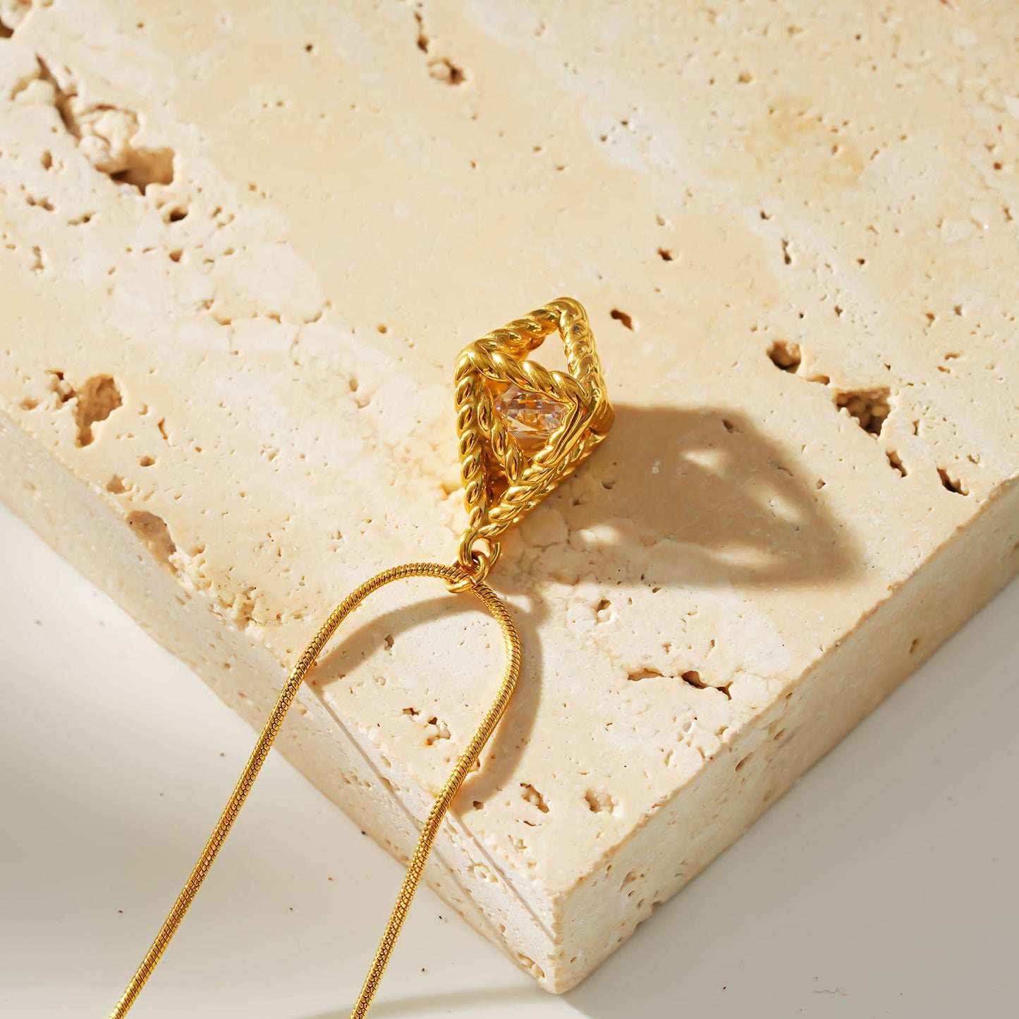 Style KARJAT: Gold Chain Necklace with Geometric Caged Zirconia Pendant