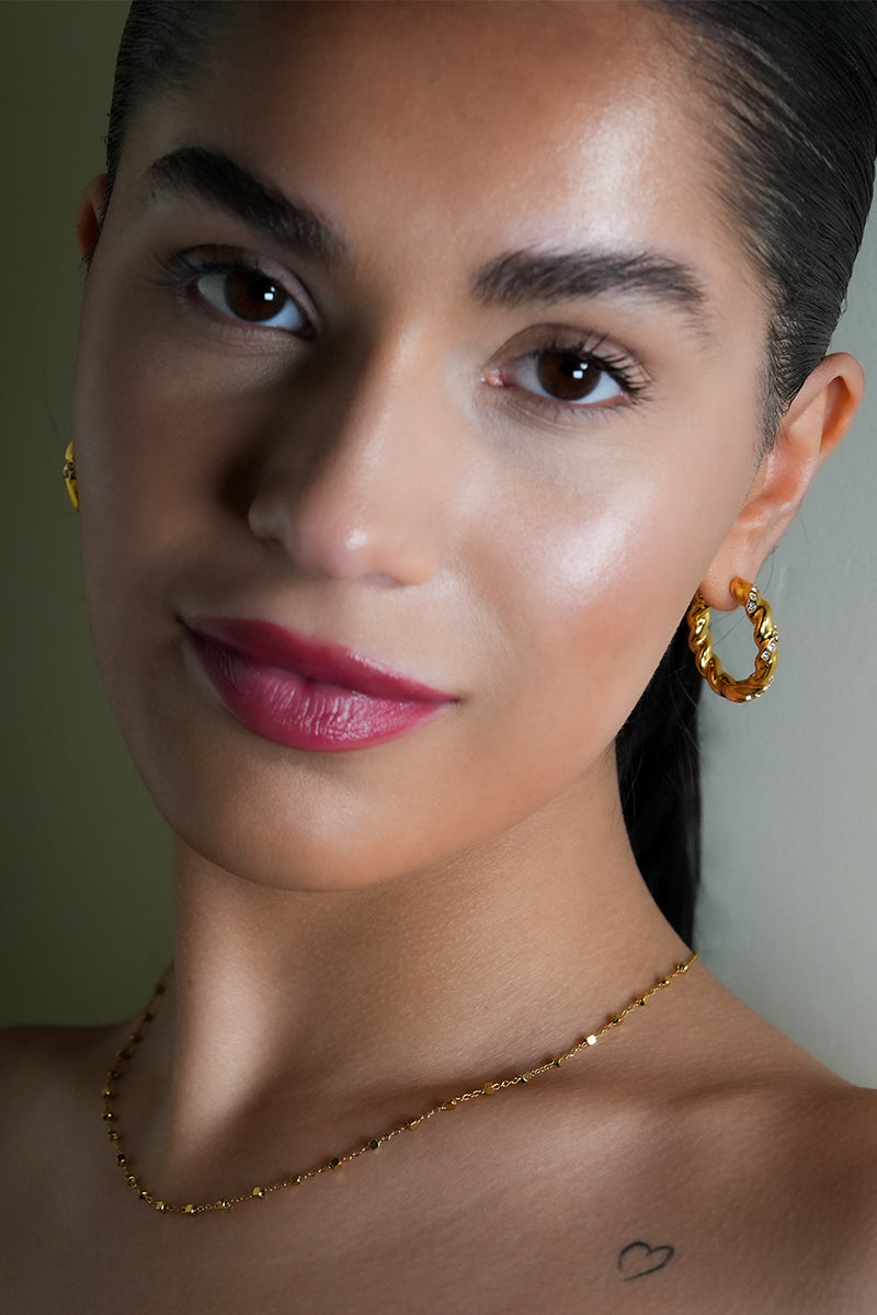 Style KAMENZ: Twisted Textured Hoop Earrings with Zirconia Embellishments.