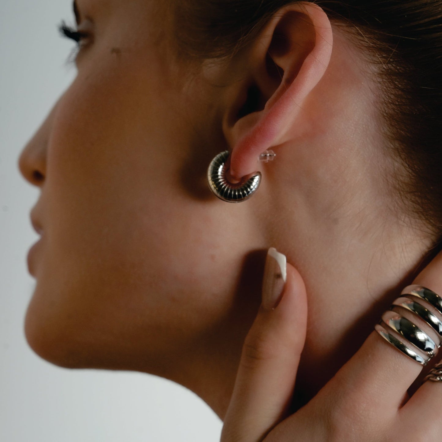 KOTOHIRA: Hollow Chunky-Look Textured Surface Tube Hoop Earrings in Silver Toned White Gold