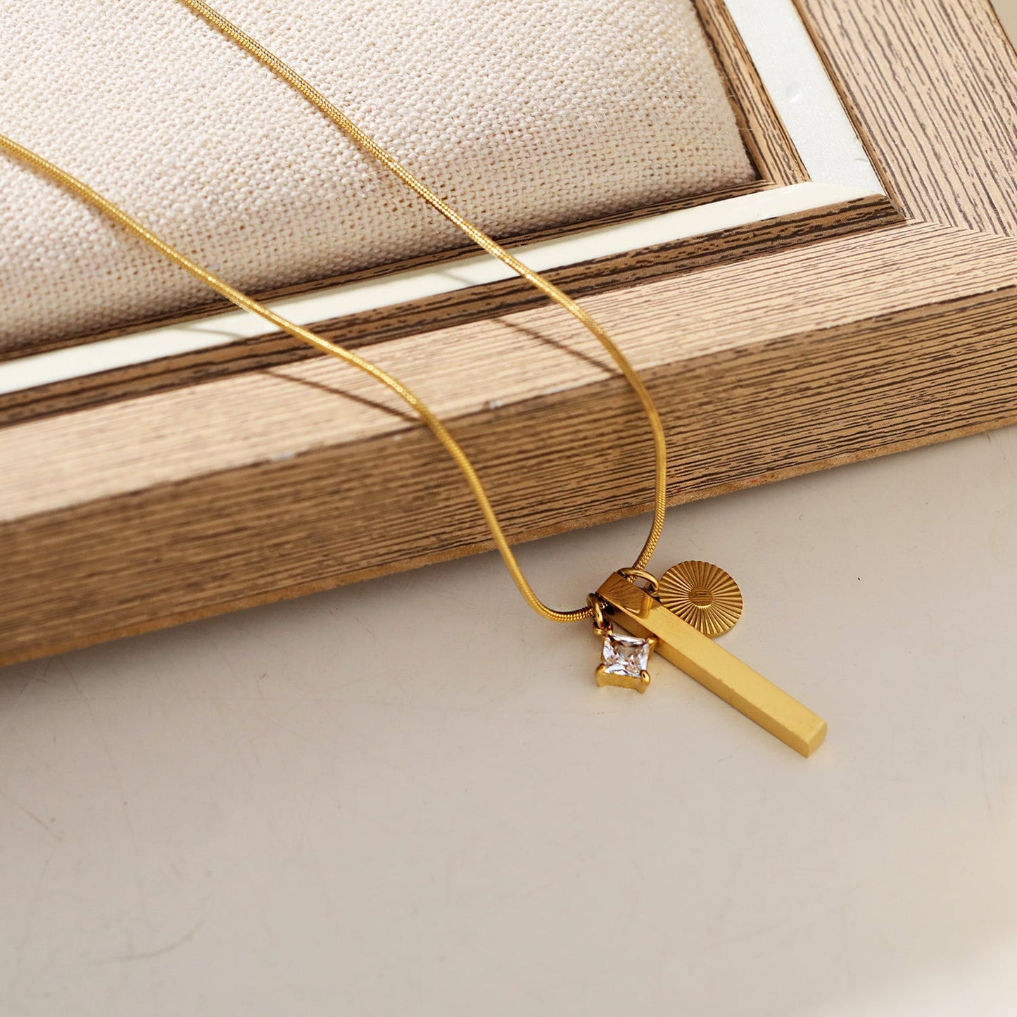 Style DEFNIE: Snake-Skin textured Dainty Chain Necklace Anchoring a Trio of Charms