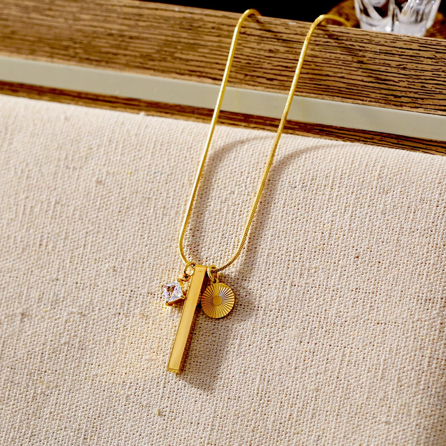 Style DEFNIE: Snake-Skin textured Dainty Chain Necklace Anchoring a Trio of Charms